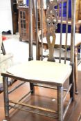 A late 19th or early 20th Century low chair having spindle and wheel back