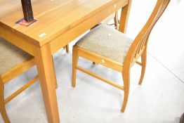 A modern golden oak dining table and four similar railback dining chairs, approx. 107 x 86cm