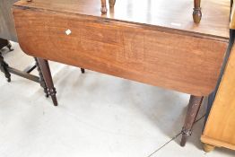 A Victorian mahogany Pembroke style dining table on turned legs, width approx.97cm