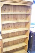 A natural pine full height bookshelf having fixed shelves, dimensions approx. height 185cm, width