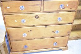 A 19th Century and later pine chest of two over three drawers having glass handles and stained