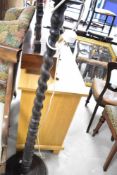 An early to mid 20th Century oak standard lamp, having twist column