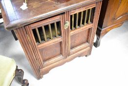 A vintage part oak side cabinet in an Oriental style, possibly dog box with lift top and brass