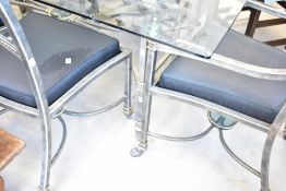 An Italian designer style glass top table with burnished metal frame and set of six (four plus