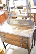 An early 20th Century oak dressing table having twist legs and mirror supports, width approx. 93cm