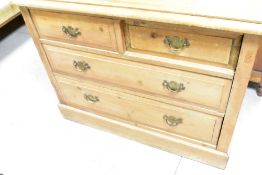A Victorian stripped pine chest of two short over two long drawers, having brass drop handles,