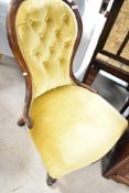 A Victorian mahogany framed spoon back nursing chair, having mustard dralon button back upholstery