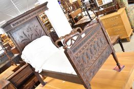 A 19th Century carved oak miniature half tester bed, either for doll or a specimen piece the head