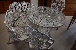 A cast style aluminium garden table, with similar bench and two chairs, table diameter approx. 71cm
