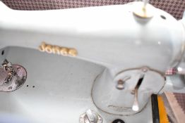 A vintage Jones handcrank sewing machine in baby blue, and carry case