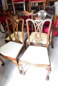 A pair of reproduction Chippendale style dining chair having ball and claw feet and a pair of