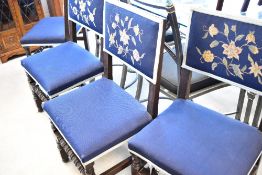 A set of four late 19th or early 20th Century dining chairs having turned frames with upholstered