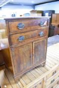 An Edwardian and mahogany bedside cabinet having two drawers over cupboard, with line inlay