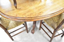 A Victorian dining or breakfast table having oval top on turned column and quadruple splay legs ,