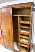 An early 20th Century walnut wardrobe, with oak fitted interior