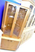 A vintage teak corner display with double cupboard to base, height approx. 170cm