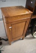 An Arts & Crafts golden oak work cabinet having lift lid with cabinet under, dimensions approx.