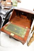 A reproduction dwarf bureau, in the Regency style with serpentine front, dimensions approx. Width