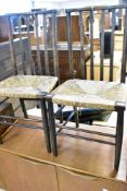 A pair of 19th Century rush seated kitchen chairs having rail back