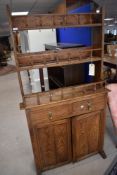 A late 19th or early 20th Century oak dresser in the Aesthetic style having open rack design over