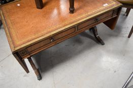 A reproduction Regency style drop end coffee table having skiver top