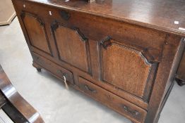 A Georgian oak coffer having three panel front and drawers to base , on bracket feet, dimensions