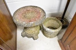 A concrete planter and similar bird bath