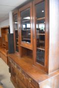 A late Victorian Arts & Crafts style oak bookcase/display with sideboard under, carved decoration