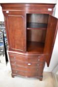 A reproduction Regency mahogany serpentine front side/cocktail cabinet with pull out slide and