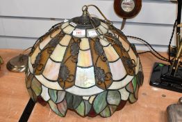 A 20th-century Tiffany-style pendant light, featuring green, cream and amber panelled decoration