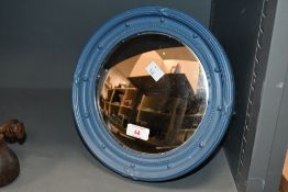 A small late 20th-century wooden porthole-style convex mirror, most likely repainted blue with areas