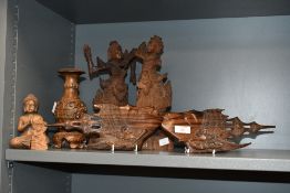 A selection of 20th-century Balinese hand carved wood wares, mostly depicting spiritual or religious