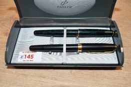 Two Parker Sonnet converter fill fountain pens. One in Matte Black with Gold trim having Parker nib,