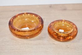 Two mid century Whitefriars-style amber glass ashtray, having controlled bubble detailing, unmarked,