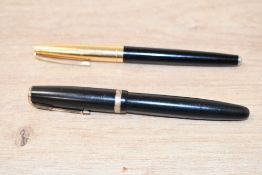 Two fountain pens. A Parker Duofold button fill fountain pen in Black and aun named plunger fill