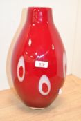 A large vintage Murano-style red and white cased art glass vase, featuring oblong white circle