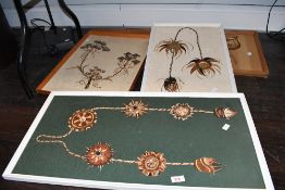 A selection of four vintage framed African artworks, crafted from natural fibres and materials and