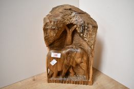 A contemporary African hardwood carving, depicting an elephant and tree, the reverse with natural '