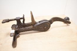 An unusual Victorian 'Original Safety' cast iron cork compressor/bottle opener, featuring decorative