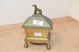 A 19th-century brass tobacco box, of sarcophagus form topped with a sweet decorative whippet/
