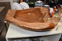 A large natural root wood bowl, thought to be teak, with shaped, dished and polished areas,