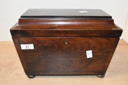 A 19th-century mahogany tea caddy, of sarcophagus form, the hinged top lifting to reveal the three
