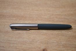 A vintage Parker 51 fountain pen, dark grey body and shiny stainless Lustraloy cap, marked.