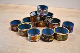 Thirteen 20th-century Chinese Cloisonné ware napkin rings, featuring a selection of colourful floral