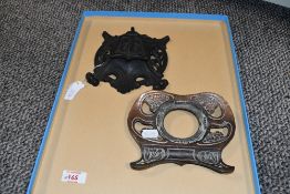 Two early 20th-century Art Nouveau metal inkwells, to feature an ornately decorated iron example