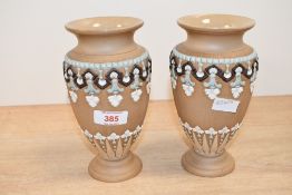 Two late 19th to early 20th-century Doulton Lambeth silicon ware bud vases, featuring applied beads,