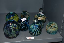 A selection of late 20th-century Mdina Art glass paperweights, featuring swirled blues, greens and