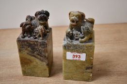 Two early 20th-century Chinese soapstone seals, featuring carved Foo-dog finials and etched