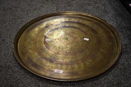A large vintage Middle East-style bras charger, featuring floral and foliate detailing, unmarked,
