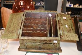 An early 20th-century rustic green painted hardwood stationery box, of traditional slope fronted